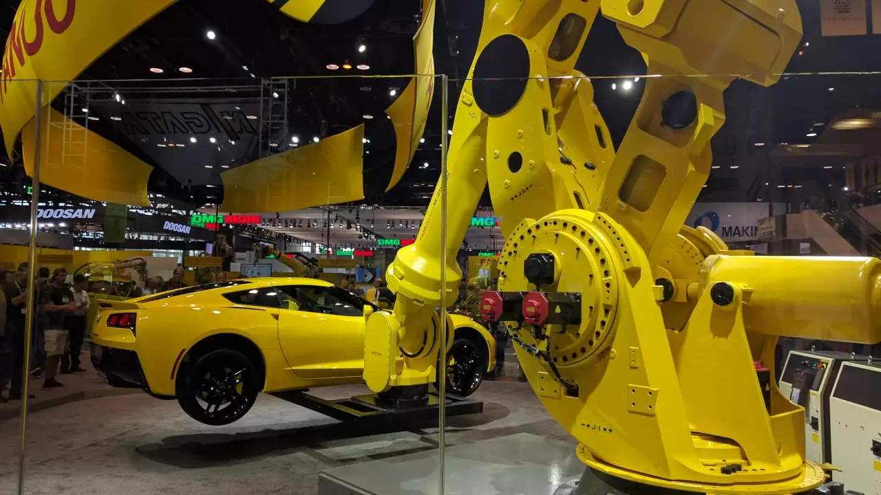 Figure 1: Fanuc robot arm picking up a car like it is nothing.