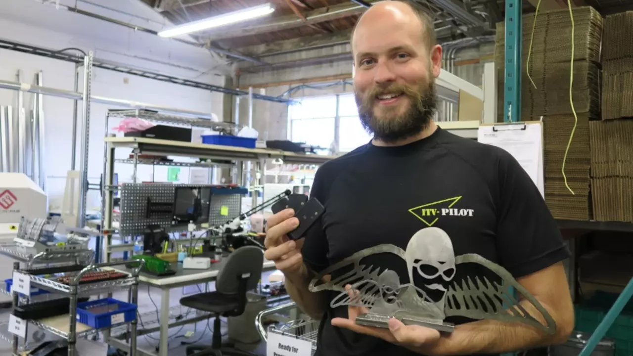 Figure 4: Trey German hold up his trophy and his paramotor monitoring flight hardware.